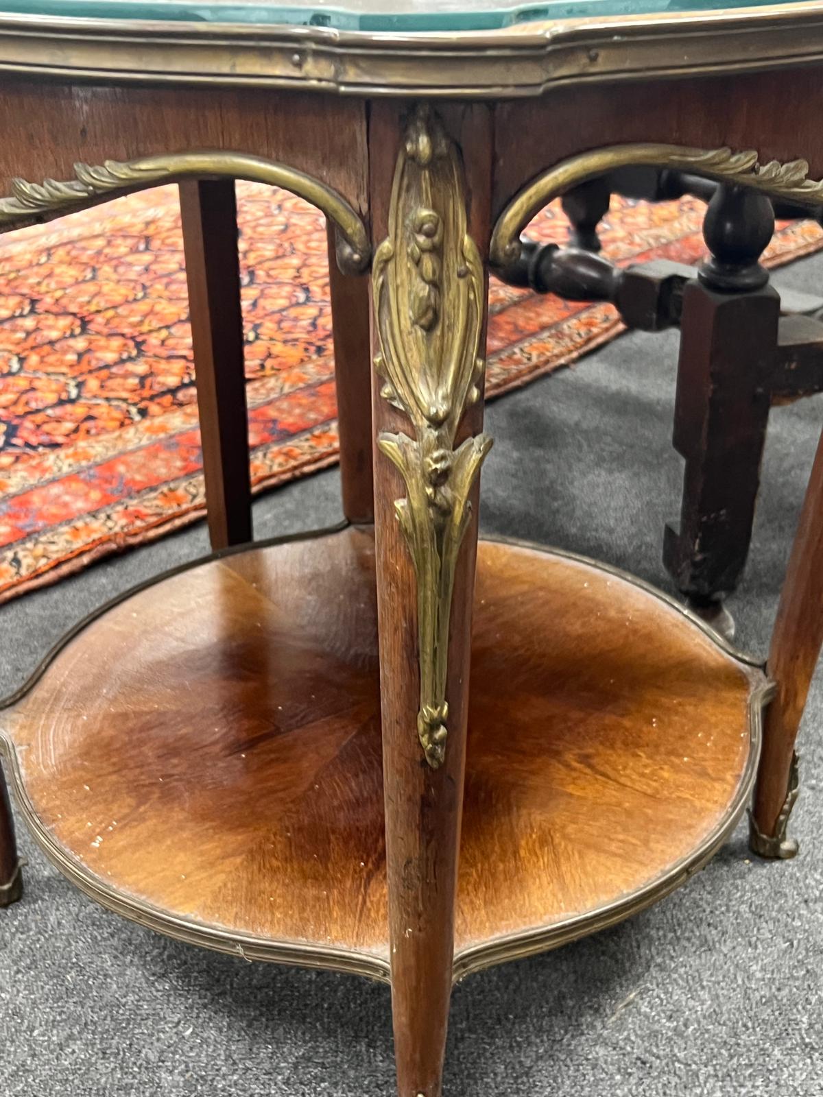 A Louis XVI style gilt metal mounted circular mahogany two tier occasional table, diameter 61cm, height 57cm